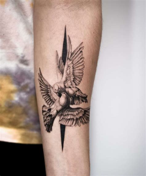 A Black And White Tattoo With A Cross Doves And A Bird On It A Black And White Tattoo With A Cross Doves And A Bird On It