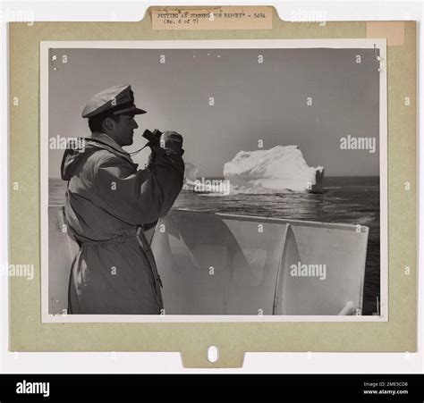 A U S Coast Guard Officer On The International Ice Patrol Examines An