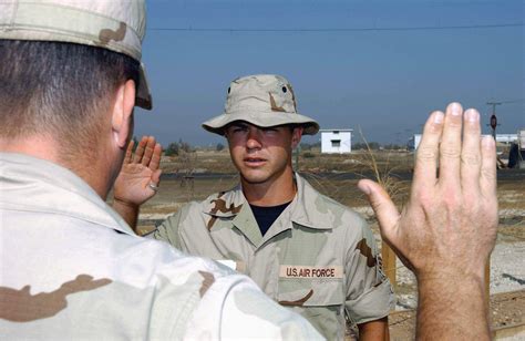 An Unidentified Us Air Force Usaf Officer Foreground Administer The Oath Of Reenlistment To Usaf Senior Airman Sra Dave Cantwell Contract Escort 438Th Expeditionary Civil Engineering Flight While Deployed At A Forward Location In Support Of