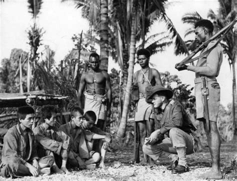 Japanese Soldiers Taken As Pows By Australian Forces At Ulebilum Ridge During The New Guinea Campaign Are Interrogated By An Australian Soldier As Three Armed Papuan Scouts Stand Guard In Maprik District