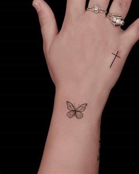 Little Butterfly And Cross Tattoos Located On The Wrist Little Butterfly And Cross Tattoos Located On The Wrist