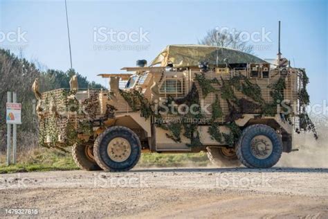 Military Truck Is Traversing A Dusty Dirt Road The Cargo Bed Of The
