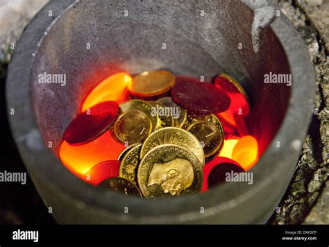 Old Gold Coins Are Melted Down In A Melting Pot At The Heraeus Gold