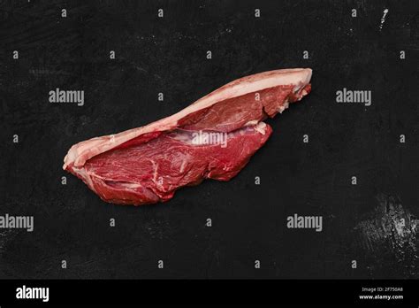 Overhead View Of Raw Beef Ribeye Lip On With Skin On Black Background Stock Photo Alamy