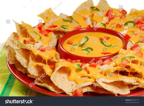 Plate Of Fresh Nachos With A Spicy Jalapeno Cheese Sauce Stock Photo