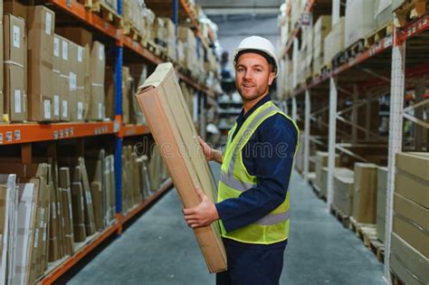 Portrait Of A Smiling Young Warehouse Worker Working In A Cash And