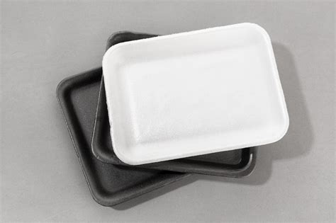 Premium Photo Disposable Black Styrofoam Food Trays On White
