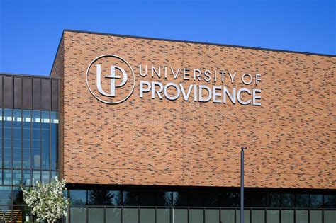 Sign On Brick Wall At University Of Providence With Catholic