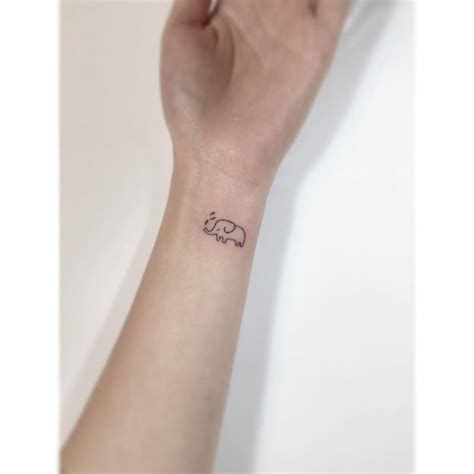 Tiny Elephant Tattoo Located On The Wrist