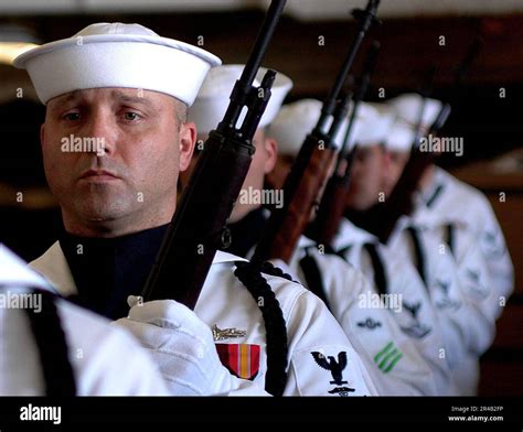 Us Navy Members Of The Ceremonial Honor Guard Stand At Port Arms During