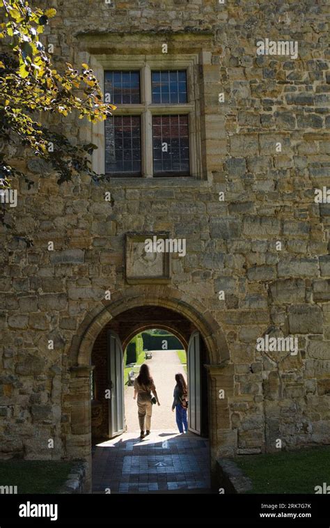 Woman Visitor Walking Past The Gate House In Penshurst Place Manor