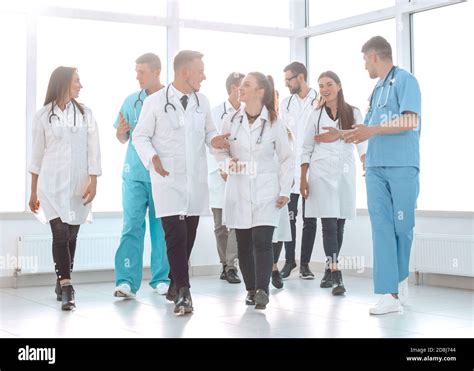 Young Medical Doctors Striding Through The Hospital Corridor Stock